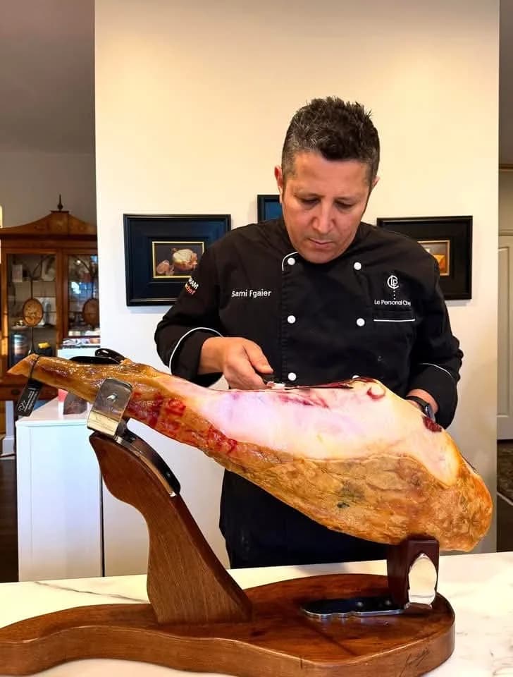 Chef Sami Fgaier preparing cured ham for service.