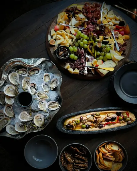 A private dining table arranged with oysters and shared plates.